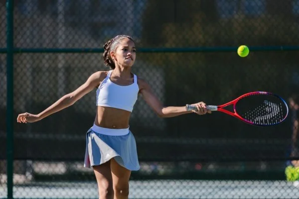 female tennis player hitting ball